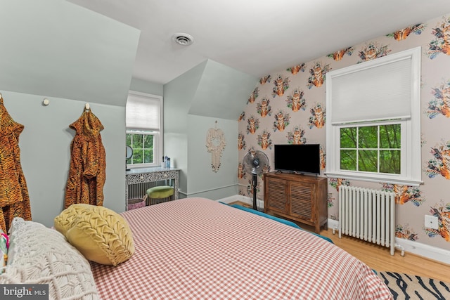 119 Burke, Towson, MD 21286 - bedroom featuring radiator heating unit, wallpapered walls, wood finished floors, baseboards, and lofted ceiling