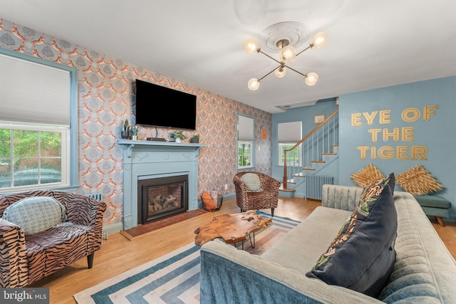 119 Burke, Towson, MD 21286 - living room with wallpapered walls, stairs, a chandelier, radiator, and wood finished floors