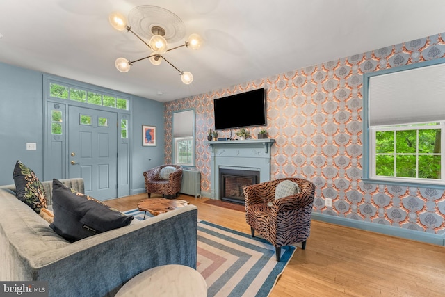 119 Burke, Towson, MD 21286 - living area featuring wallpapered walls, baseboards, a chandelier, wood finished floors, and healthy amount of natural light