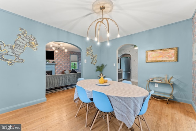 119 Burke, Towson, MD 21286 - dining area with arched walkways, wood finished floors, a fireplace, baseboards, and wallpapered walls