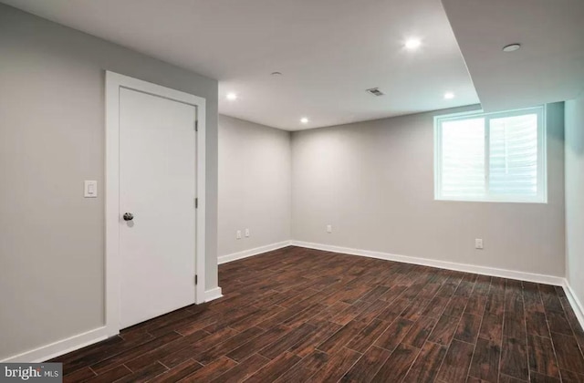 below grade area featuring dark wood-style floors, baseboards, and recessed lighting