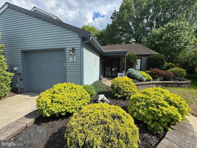 view of front of home featuring a porch and a garage
