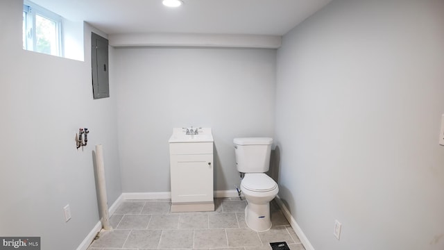 half bathroom with electric panel, toilet, baseboards, recessed lighting, and tile patterned flooring