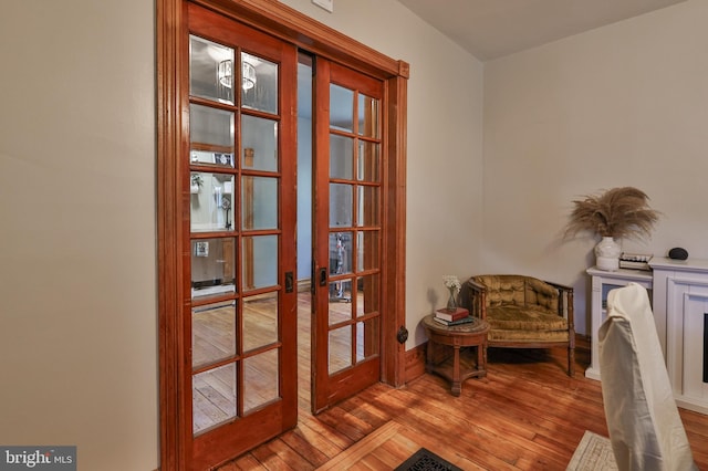 living area featuring hardwood / wood-style flooring and french doors