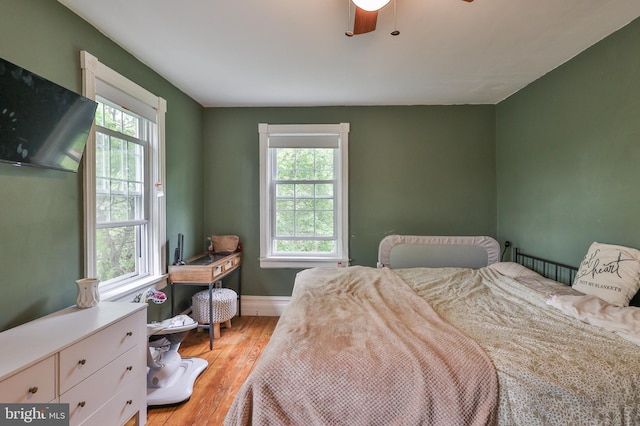 bedroom featuring light wood-type flooring and baseboards