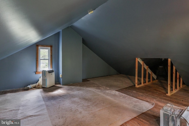 bonus room with lofted ceiling and wood finished floors