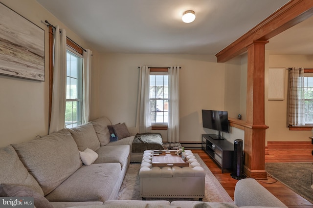 living area featuring wood finished floors and a baseboard heating unit