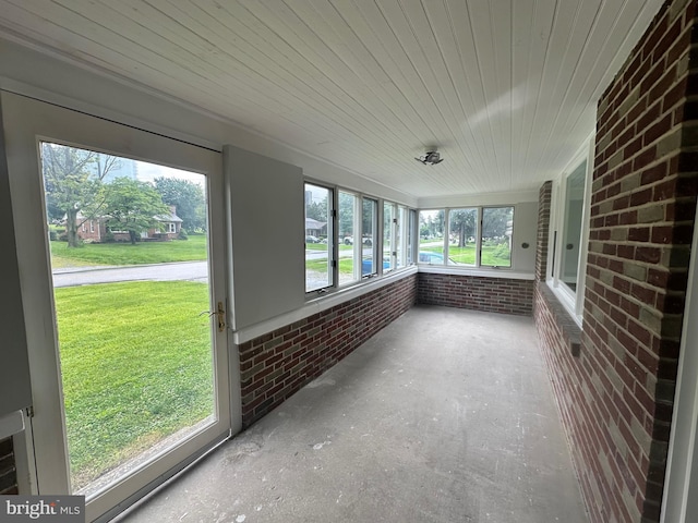 3333 Stone Ridge Rd, York, PA 17402 - unfurnished sunroom featuring brick wall, wooden ceiling, and concrete floors