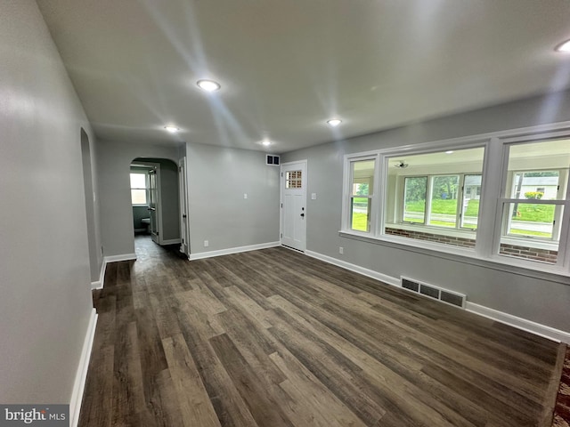 3333 Stone Ridge Rd, York, PA 17402 - unfurnished living room with arched walkways, plenty of natural light, dark wood-style flooring, recessed lighting, and baseboards