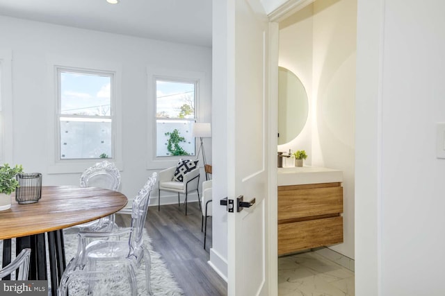 bathroom with vanity, baseboards, and marble finish flooring