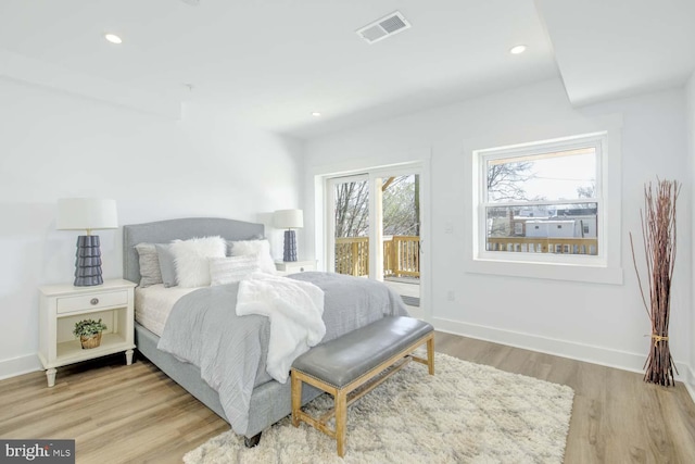 bedroom with access to outside, wood finished floors, baseboards, and recessed lighting