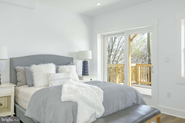 bedroom with access to exterior, baseboards, and wood finished floors