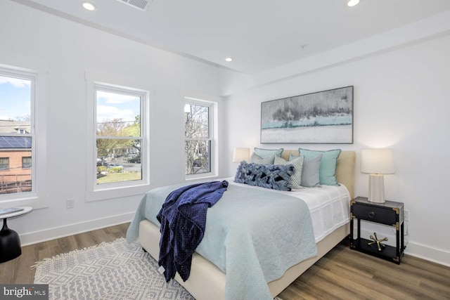 bedroom with wood finished floors, recessed lighting, and baseboards