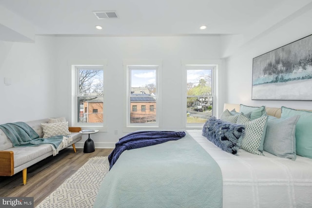 bedroom featuring multiple windows, wood finished floors, recessed lighting, and baseboards