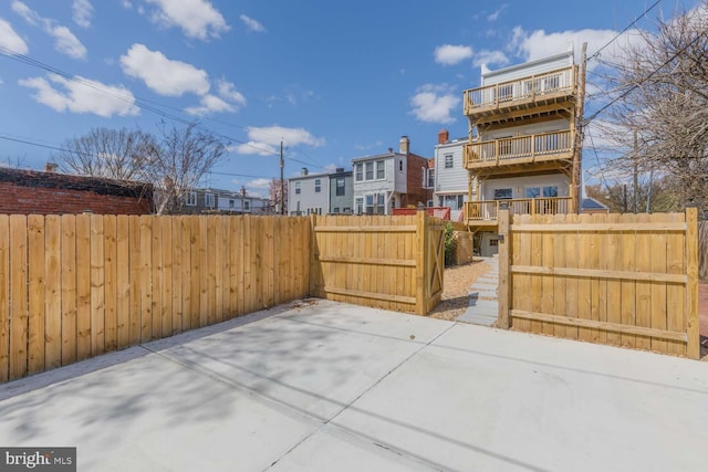 view of patio with a fenced backyard and a balcony