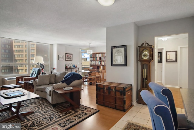 205 E Joppa Rd Unit 608, Towson, MD 21286 - living area featuring a textured ceiling, light tile patterned floors, and a chandelier