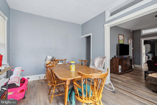 dining room with wood finished floors and baseboards