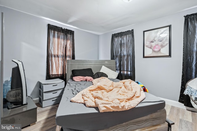 bedroom featuring wood finished floors