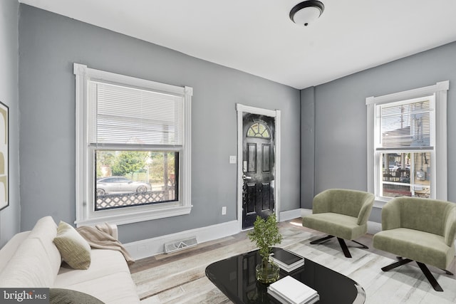 living room with light wood-type flooring and baseboards