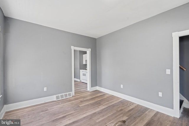unfurnished room featuring wood finished floors and baseboards