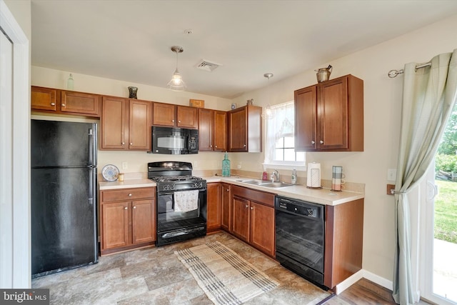1550 Matthew Dr, York, PA 17404 - kitchen with black appliances, a sink, and brown cabinetry