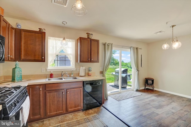 1550 Matthew Dr, York, PA 17404 - kitchen featuring black appliances, a sink, light wood-style flooring, brown cabinets, and light countertops