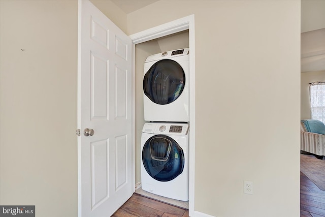 1550 Matthew Dr, York, PA 17404 - laundry room featuring stacked washer / drying machine and wood-type flooring