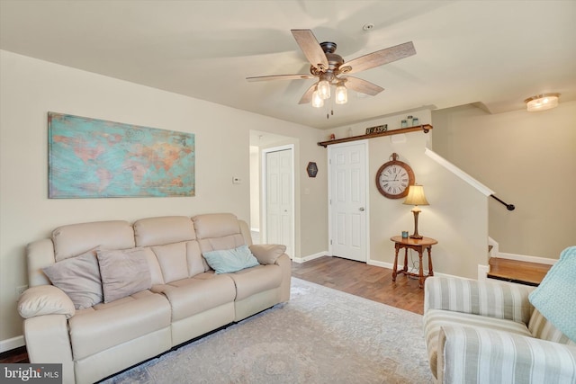 1550 Matthew Dr, York, PA 17404 - living room with wood finished floors, baseboards, ceiling fan, and stairway