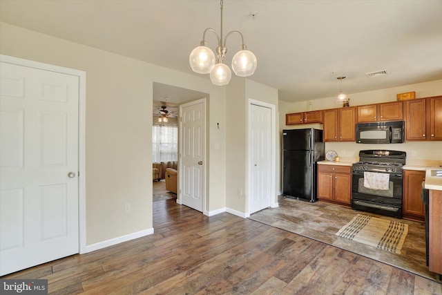 1550 Matthew Dr, York, PA 17404 - kitchen with black appliances, hardwood / wood-style flooring, brown cabinets, light countertops, and ceiling fan