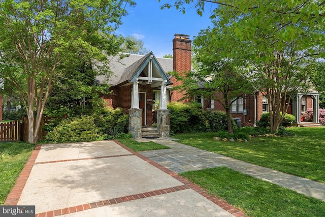 view of front of home featuring a chimney and brick siding
