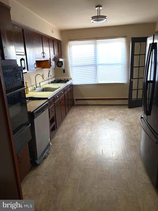 446 N Daggett St, Philadelphia, PA 19151 - kitchen featuring stainless steel appliances, a sink, a baseboard radiator, and dark brown cabinetry