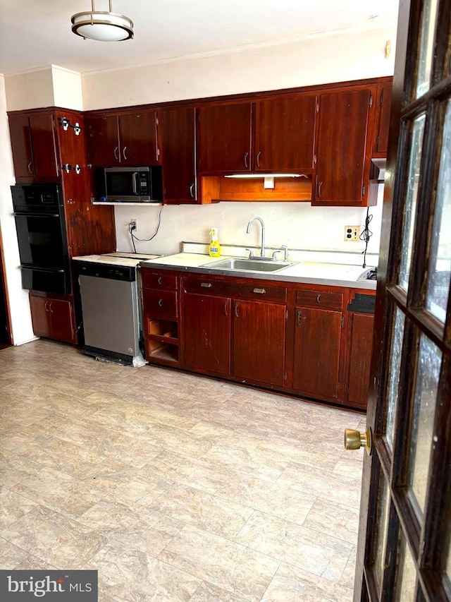 446 N Daggett St, Philadelphia, PA 19151 - kitchen with a sink, appliances with stainless steel finishes, a warming drawer, light countertops, and dark brown cabinets
