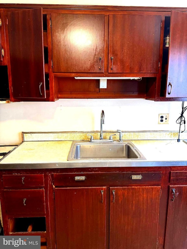 446 N Daggett St, Philadelphia, PA 19151 - kitchen with a sink, light countertops, and dark brown cabinets
