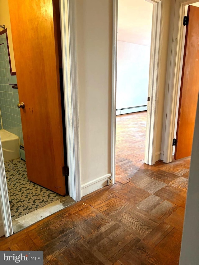446 N Daggett St, Philadelphia, PA 19151 - hallway featuring baseboard heating, a baseboard radiator, and tile walls