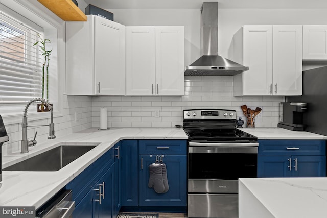 1807 N 27th St, Philadelphia, PA 19121 - kitchen with stainless steel appliances, wall chimney range hood, blue cabinetry, and a sink