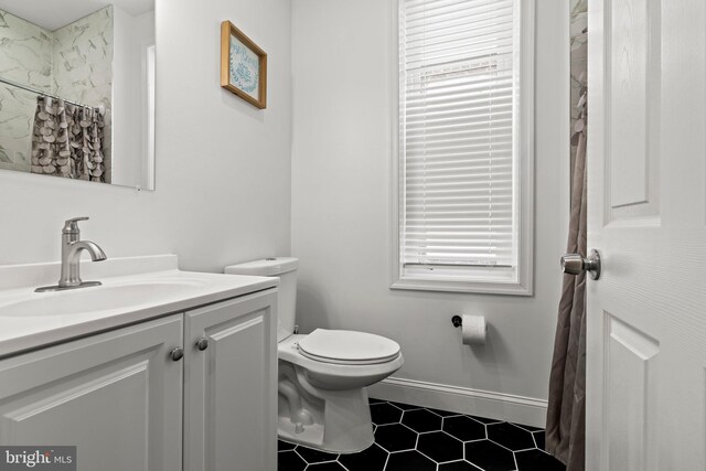 1807 N 27th St, Philadelphia, PA 19121 - bathroom with toilet, tile patterned flooring, vanity, baseboards, and healthy amount of natural light