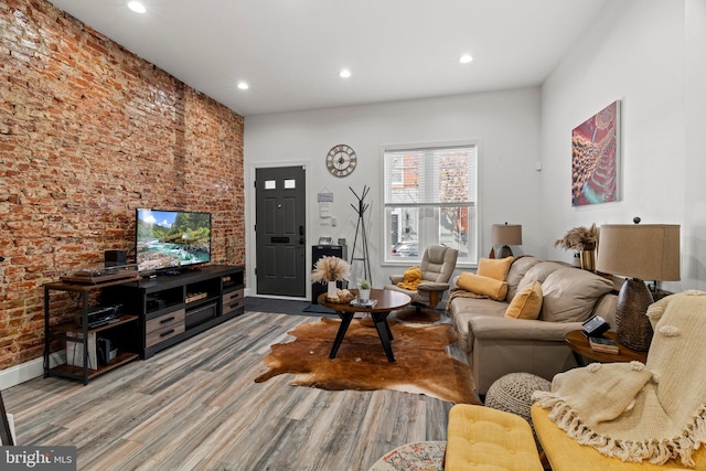 1807 N 27th St, Philadelphia, PA 19121 - living area featuring wood finished floors, recessed lighting, brick wall, and baseboards