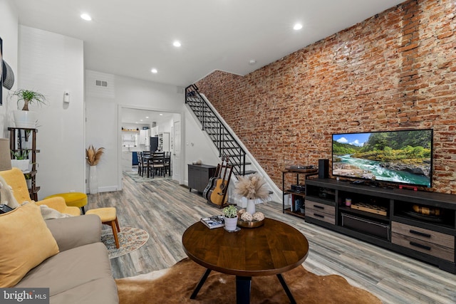 1807 N 27th St, Philadelphia, PA 19121 - living area with wood finished floors, stairs, brick wall, recessed lighting, and baseboards