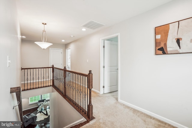 hallway with an upstairs landing, baseboards, carpet, and recessed lighting