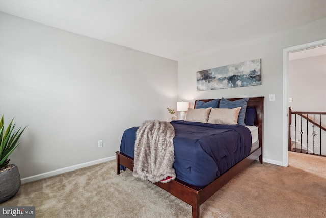 carpeted bedroom featuring baseboards