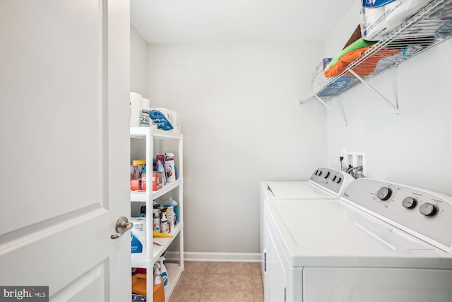 laundry area featuring separate washer and dryer and baseboards