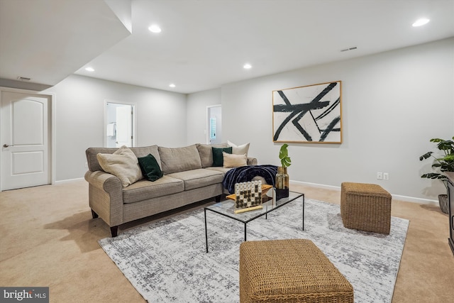 carpeted living area with recessed lighting and baseboards