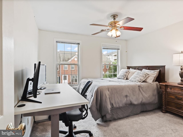 bedroom featuring carpet floors, an office area, and ceiling fan