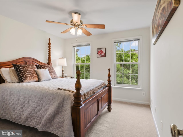 bedroom with baseboards, light colored carpet, and a ceiling fan