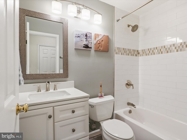bathroom featuring toilet, vanity, and shower / washtub combination