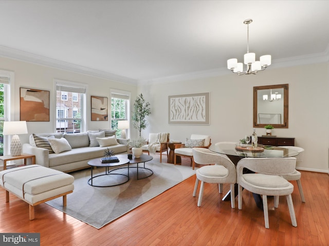 living room with a chandelier, healthy amount of natural light, hardwood / wood-style flooring, and crown molding