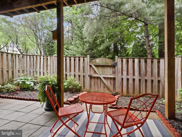 view of patio / terrace featuring a gate and fence