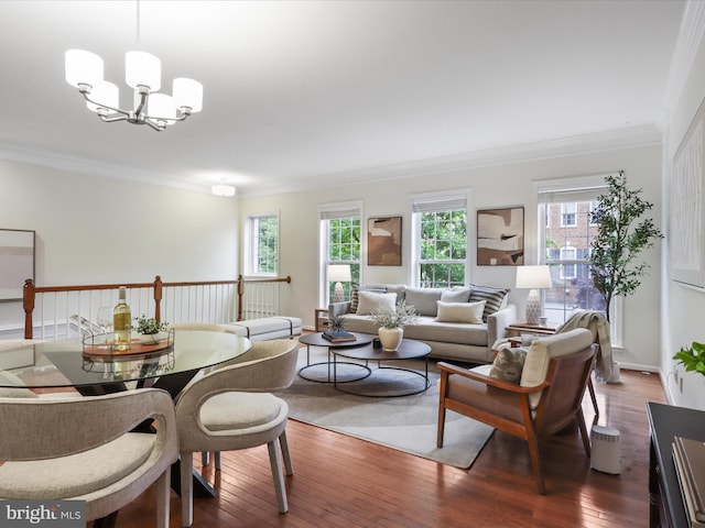 living area with plenty of natural light, ornamental molding, dark wood-style flooring, and a chandelier