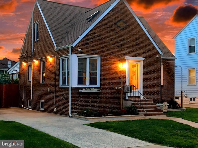 1918 Maxwell Ave, Baltimore, MD 21222 - tudor home featuring brick siding, a shingled roof, and a lawn