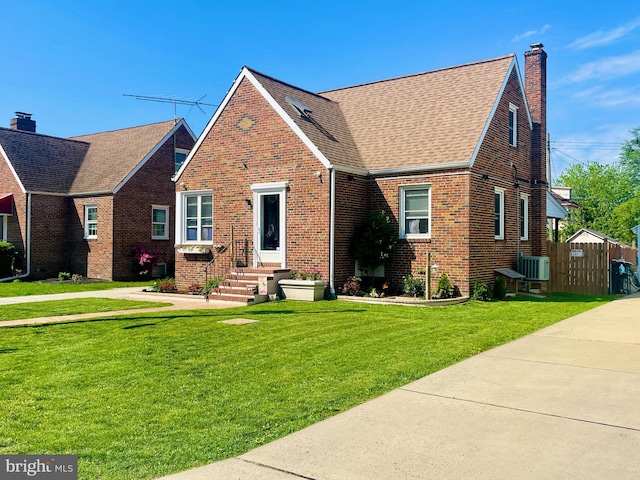 1918 Maxwell Ave, Baltimore, MD 21222 - english style home with a chimney, brick siding, a shingled roof, and central air condition unit